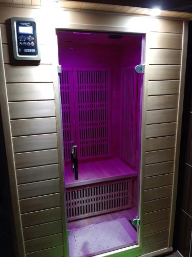 a pink shower in a bathroom with a scale at Piros Ponty Panzió in Poroszló