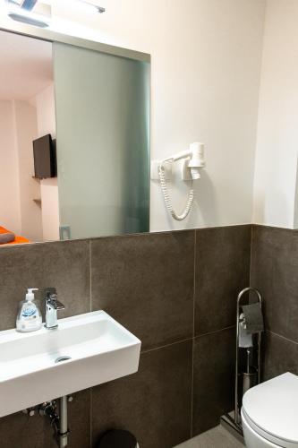 a bathroom with a sink and a mirror at Hostel Museum in Koper