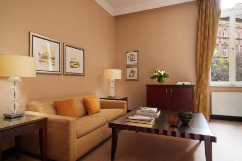 a living room with a couch and a table at Corinthia Budapest in Budapest