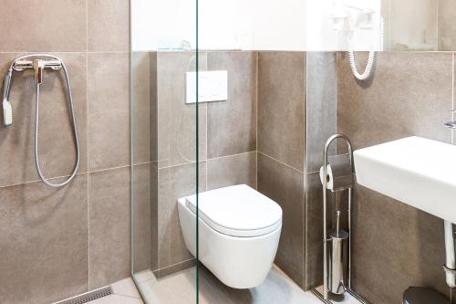 a bathroom with a toilet and a sink at Hostel Museum in Koper