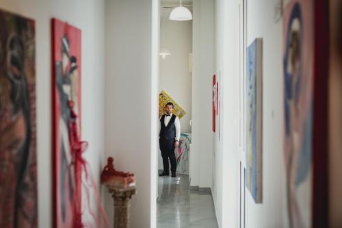 a man in a suit holding an umbrella in a hallway at Il vecchio Fauno in Pompei