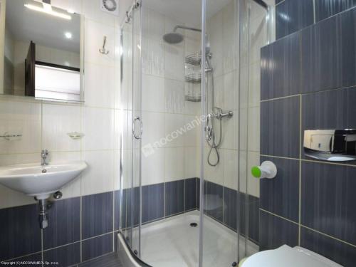 a bathroom with a shower and a toilet and a sink at Apartamenty Rodzinne in Kudowa-Zdrój