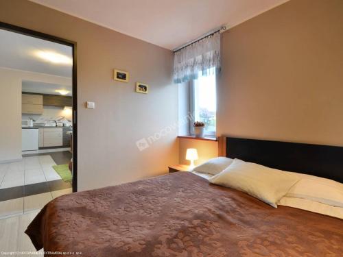 a bedroom with a large bed and a large mirror at Apartamenty Rodzinne in Kudowa-Zdrój