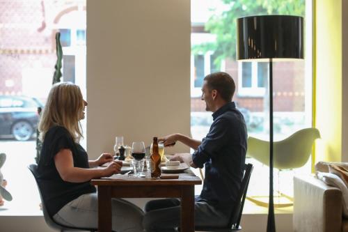 a woman and a man sitting at a table at Townhouse Design Hotel & Spa in Maastricht