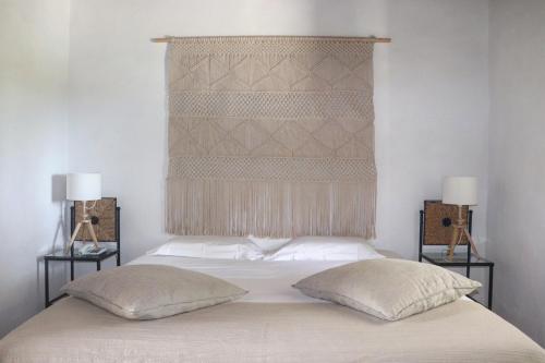 a bedroom with a large bed with two pillows at Quinta Do Mel in Albufeira