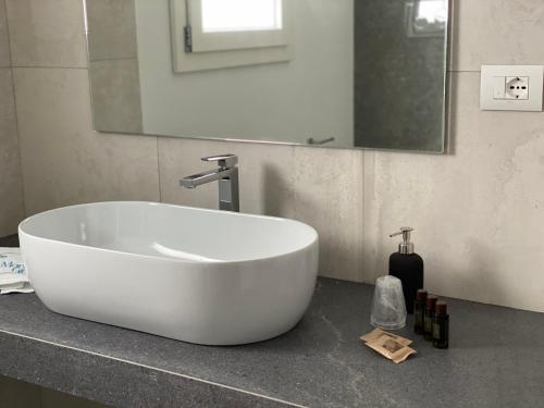 a white tub sitting on a counter in a bathroom at Il Mare di Giù Boutique Guesthouse in Licata