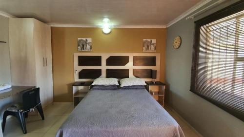 a bedroom with a large bed in a room at Genesis Self Catering Apartments in Bloemfontein