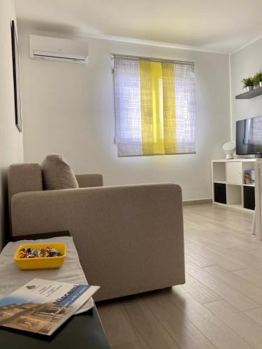 a living room with a couch and a table at Appartamento D & D in Niscemi