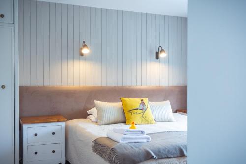 a bedroom with a bed with two towels on it at Chester House Hotel in Bourton on the Water