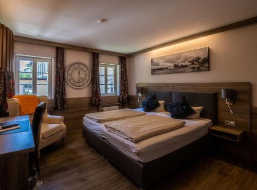 a bedroom with a large bed and a desk at Waldhaus Jakob in Konstanz