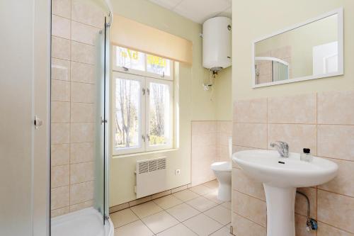 a bathroom with a sink and a toilet and a window at Holiday Home Viktorija B in Jūrmala