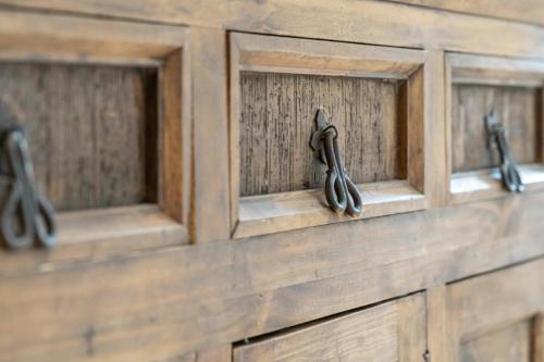 a row of wooden cabinets with black handles at Bergwelt-M in Schröcken