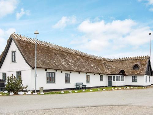 un edificio blanco con techo marrón en 2 person holiday home in Gilleleje, en Gilleleje