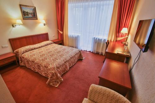 a hotel room with two beds and a window at Ukraina Hotel in Cherkasy