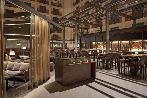 a restaurant with tables and chairs in a building at Hyatt Regency San Francisco Airport in Burlingame