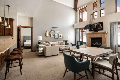 a living room with a table and a fireplace at Hyatt Centric Park City in Park City