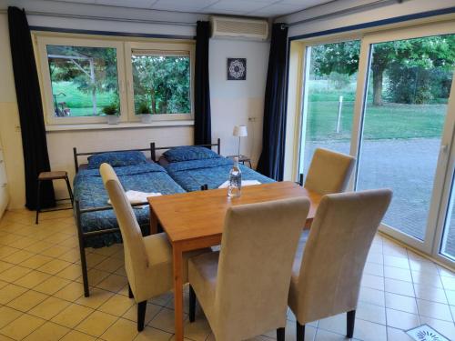 a dining room with a table and a couch at Guest House Ons Hoekje in Houten