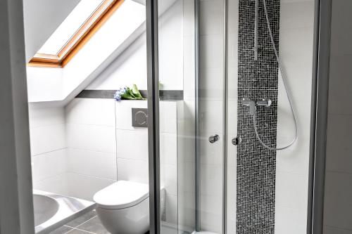 a bathroom with a toilet and a shower at Hotel Julian in Prague