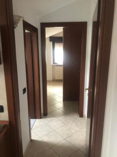 a hallway with a door and a tile floor at B&B Le Due Gemme Marsaglia in Marsaglia