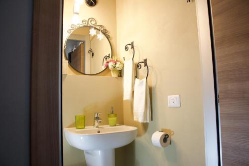 a bathroom with a sink and a mirror at La Casa Sul Sasso in Dervio