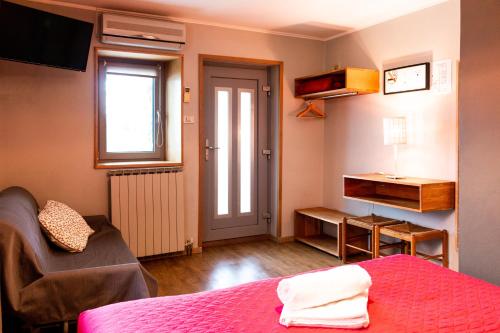 a room with a bed a chair and a window at Hostel Museum in Koper