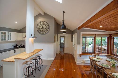 a kitchen and dining room with a table and chairs at Oak Tree Lodge in Rhyll