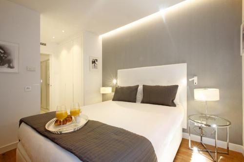 Postel nebo postele na pokoji v ubytování Gran Via Suites