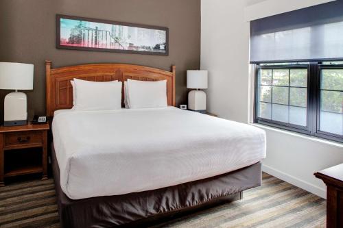 a bedroom with a large white bed and a window at Hyatt House Parsippany East in Parsippany