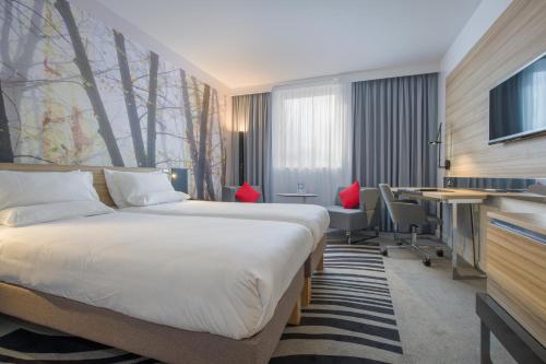 a hotel room with a bed and a desk at Novotel York Centre in York