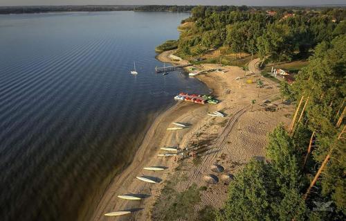 an aerial view of a beach with boats in the water at Hotel Marina in Nielisz