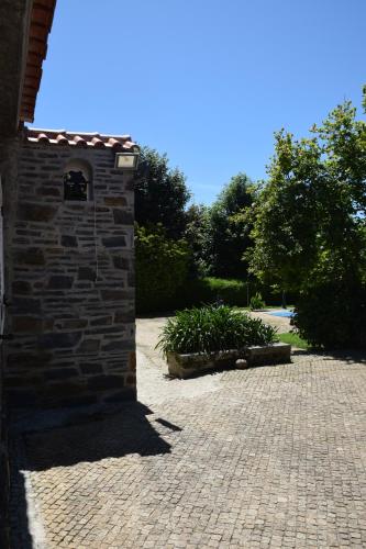 a brick building with a brick courtyard with plants at Quinta da Boa Ventura in Bragança