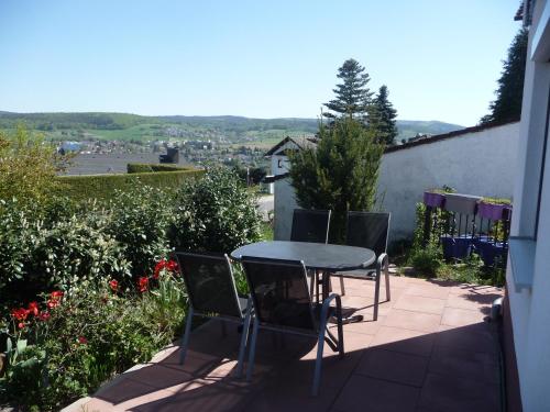 a table and chairs on a patio with a view at Ferienwohnung chez nous in Erbach im Odenwald