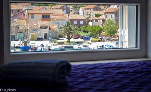 a room with a window with a view of a marina at Galeb 2 in Veli Iž