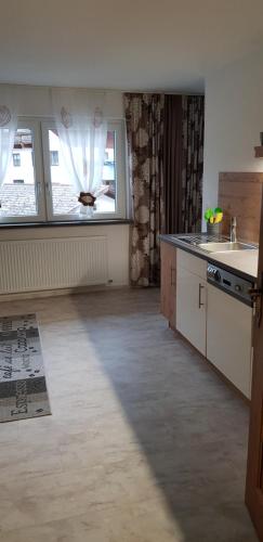 an empty kitchen with a large window and a kitchen counter at Haus Sonnblick in Wangle
