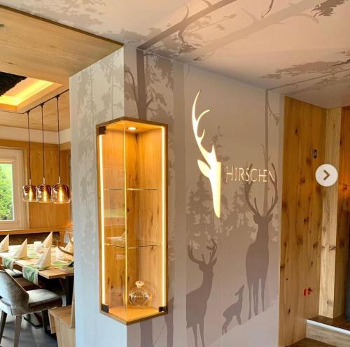 a restaurant with a wall with deer decals on it at Hotel Hirschen in Schluchsee