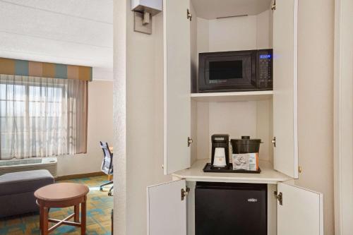 a hotel room with a microwave and a room at La Quinta by Wyndham Ft. Lauderdale Plantation in Plantation