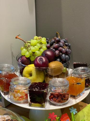 a plate of fruit and vegetables on a table at Art B&B Design in Costa Volpino