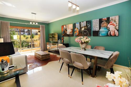 a dining room with a table and chairs at HENRI'S APARTMENTS - Pátio do Convento in Lagos