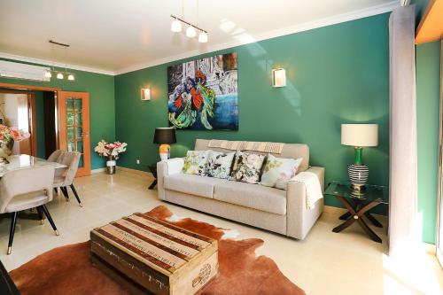 a living room with a couch and a table at HENRI'S APARTMENTS - Pátio do Convento in Lagos