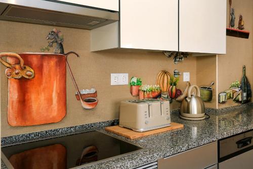 a kitchen counter with a toaster on a counter top at HENRI'S APARTMENTS - Pátio do Convento in Lagos