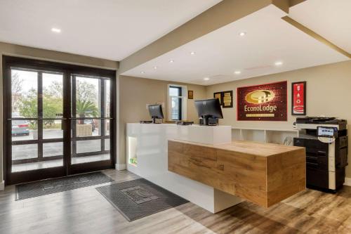 a large office with a desk with avertisement for at Travelodge by Wyndham North Charleston in Charleston
