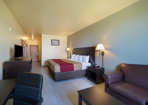 une chambre d'hôtel avec un lit et un canapé dans l'établissement Econo Lodge Inn & Suites Bridgeport, à Bridgeport