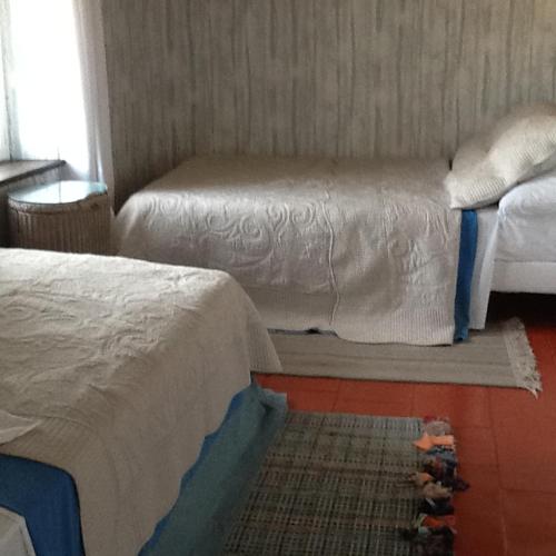 a room with two beds and a window at L'Orchidée in Ginestas