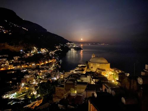 a view of a city at night with the water at Casa Positamo in Positano