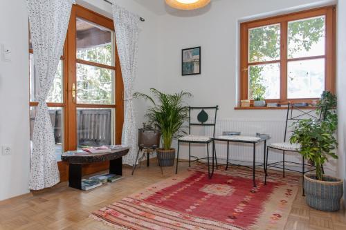 a living room with a table and some plants at Ferienwohnungen Knippschild in Lofer