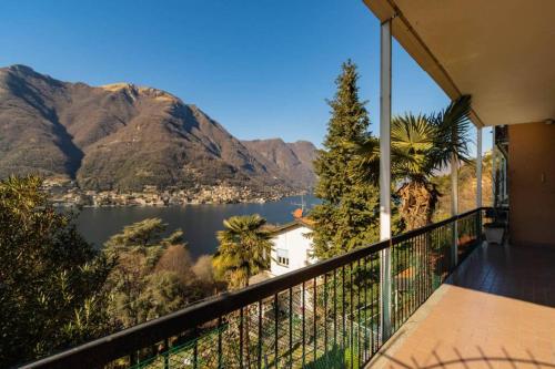 a balcony with a view of a lake and mountains at The Palm in Pognana Lario