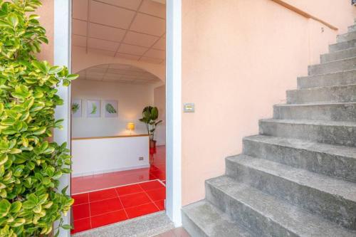 a staircase in a house with a red tile floor at The Palm in Pognana Lario