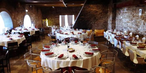 a room with tables and chairs with white tablecloths at HI Serra da Estrela - Pousada de Juventude in Penhas da Saúde