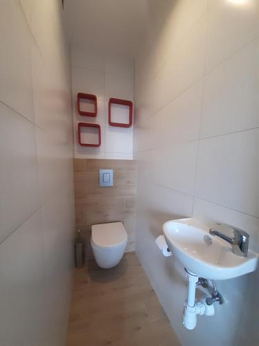 a bathroom with a sink and a toilet at Pensjonat Maja in Nowy Sącz
