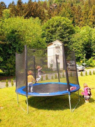a group of children playing on a trampoline at Kozma Apartments Peterlewand Gerlitzen Ossiachersee in Bodensdorf